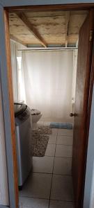 a bathroom with a toilet and a trash can at Cabaña Quemchi in Quemchi