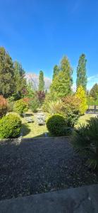 ein Garten mit einem Picknicktisch im Gras in der Unterkunft Valkara Patagonia in Las Golondrinas
