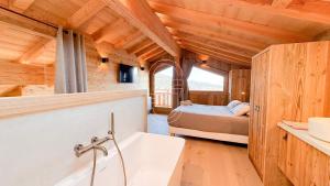 a bathroom with a bed and a tub in a room at Chalet Agane proximité pistes immédiate in Les Angles