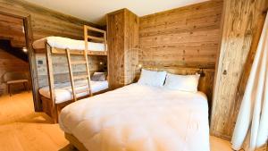 a bedroom with two bunk beds and a ladder at Chalet Agane proximité pistes immédiate in Les Angles +11 photos