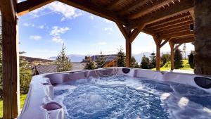 a hot tub in a gazebo at Chalet Agane proximité pistes immédiate in Les Angles