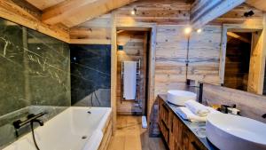a bathroom with a tub and a sink at Chalet Ski Bob pied de pistes jacuzzi in Font-Romeu +15 photos