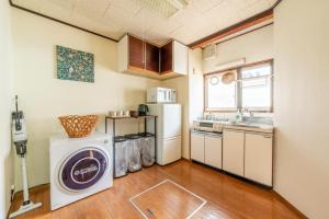 a small kitchen with a washing machine in it at GUEST HOUSE Hotori in Otsu +24 photos