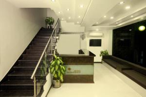 a staircase in a building with potted plants at Hotel Metropolitan in Jaipur