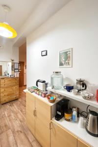 a kitchen with white counters and a counter top at Europe Station House in Parma