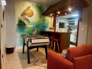 a room with a ping pong table in a kitchen at Le Courlis du Ried in Grussenheim