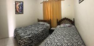 Postel nebo postele na pokoji v ubytování Hospedaje Maluli 02