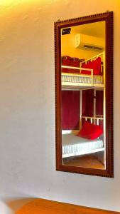 a mirror reflection of a room with bunk beds at Mitra Hostel Vagator in Vagator