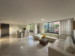 a living room with a couch and a table at 4br 232 M Apartment In El Poblado, El Tesoro in Medellín