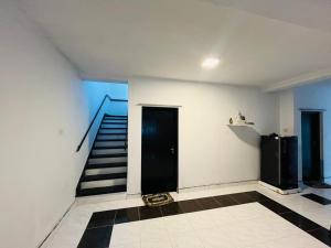 a room with a staircase and a black door at The Crown's lodge Nuwara Eliya in Nuwara Eliya