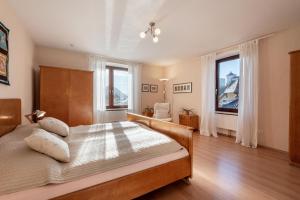 a bedroom with a bed and a large window at Villa Gartenblick in Kufstein