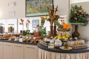 a buffet of food on a counter in a room at Ambassador Suite Hotel in Riva del Garda