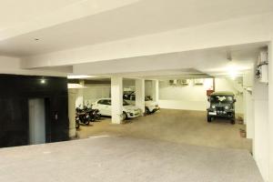a garage with cars and motorcycles parked in it at Hotel Metropolitan in Jaipur