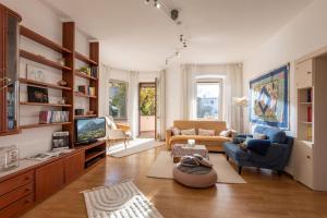a living room with a couch and a tv at Villa Gartenblick in Kufstein