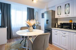 a kitchen with a table and chairs in a kitchen at Apartament de închiriat Accommodation nr 12 in Suceava +42 photos