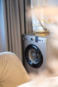 a washing machine in a room with a curtain at Apartament de închiriat Accommodation nr 12 in Suceava