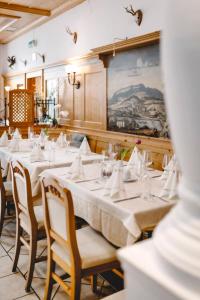 a dining room with a long table with white table cloth at Hotel Goisererhof in Bad Goisern