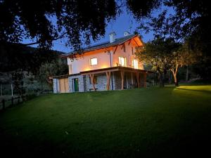 a house sitting on top of a lush green field at Casa Luigina in Verrayes