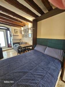 a bedroom with a bed with a blue comforter at Le Antiche Travi in Bari