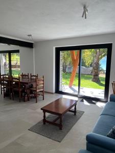 a living room with a blue couch and a table at Casa Luigina in Verrayes