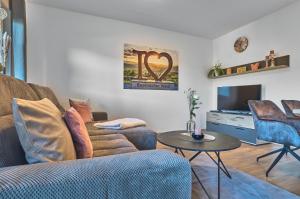 a living room with a couch and a table at Ferienwohnungen Geiger in Bodenmais