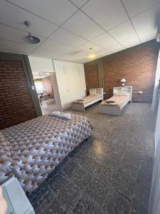 a room with three beds in a room at Alojamiento cuyum in Rivadavia