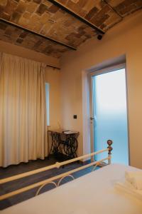 a bedroom with a bed and a large window at B&B Lilà in Chieti