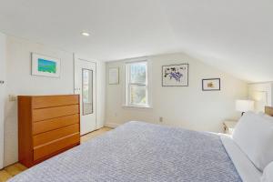 a white bedroom with a bed and a dresser at Ledgewood 7 in Seal Harbor