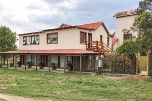 ein Haus mit einem Zaun davor in der Unterkunft Corner View Accommodation in Kaapsehoop