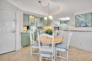 a kitchen and dining room with a table and chairs at Beach Club #414 in Saint Simons Island