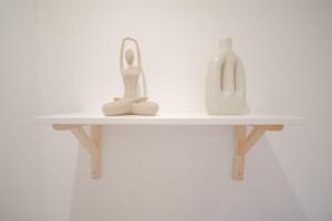 a shelf with a scissors and a bottle on it at Apartamento do Sol, Lobão 