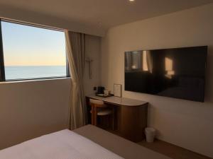 TV a/nebo společenská místnost v ubytování H avenue Songjeong + 24 fotografií