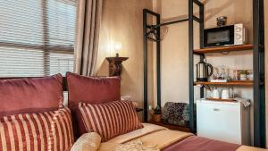 a living room with a couch with pillows at Figtree Escape in Marloth Park