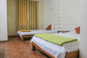 Giường trong phòng chung tại Thiên Tân Hotel