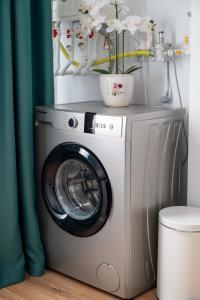 a washing machine in a room with a green curtain at Apartament de închiriat Accommodation nr 10 in Suceava