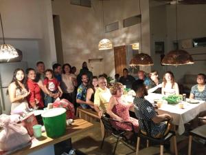 a group of people sitting at tables in a room at Private rainforest villa up to 8 guests w jacuzzi near Rio Celeste in Upala