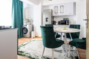 a kitchen and dining room with a table and chairs at Apartament de închiriat Accommodation nr 10 in Suceava +42 photos