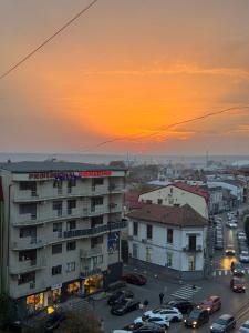 a sunset over a city with cars parked in a parking lot at Abe Studio in Craiova