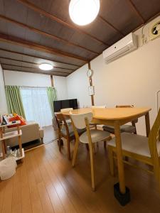 a living room with a dining room table and chairs at Minpaku SAKURA 民泊 戸建貸切 彦根城まで車10分 無料駐車場 普通2台小型1台 in Hikone