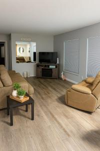 a living room with a couch and a flat screen tv at Oceanfront Retreat Private Beach New Smyrna Beach in New Smyrna Beach