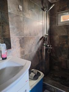 a bathroom with a sink and a shower at Apartment Mia in Vrnjačka Banja +36 photos