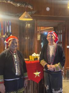 two women standing next to each other in a room at Bản Sù - Homestay in Sa Pa