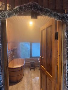 a large wooden tub in a room with a window at Bản Sù - Homestay in Sa Pa +21 photos