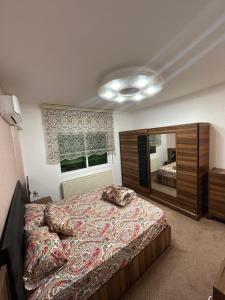 a bedroom with a large bed and a large mirror at Toum's Apartments 2 in Amman
