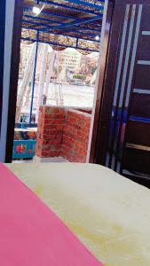 a room with a brick wall and a window at Onaty Narty Guest house Nile view in Aswan