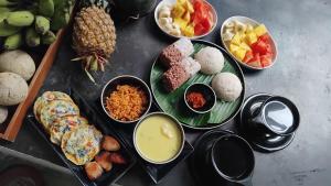 a table topped with different types of food on plates at Sesatha waters edge villa in Tangalle +47 photos