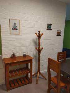 a room with a table and two wooden furniture at Dptos Ceci in Centenario