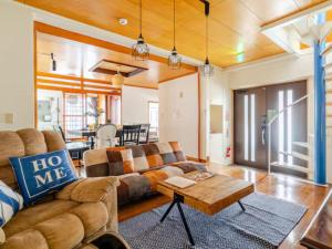 un salon avec un canapé et une table dans l'établissement 【NewOpen】人気の観光地北谷に立地! 最大14名様, à Hamakawa