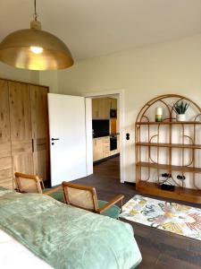 a room with a table and chairs and a kitchen at Strumpfburg by Dollop Living in Kramsach +7 photos