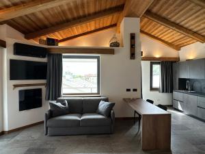 a living room with a couch and a table at Valtellina SkyLine OVEST in Villa di Tirano